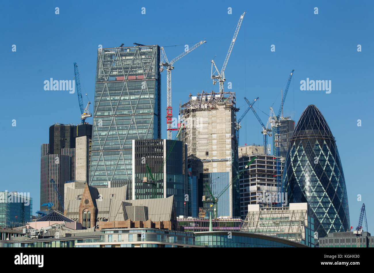 London city skyline seen from the river thames as cranes work on new buildings in the square mile Stock Photo