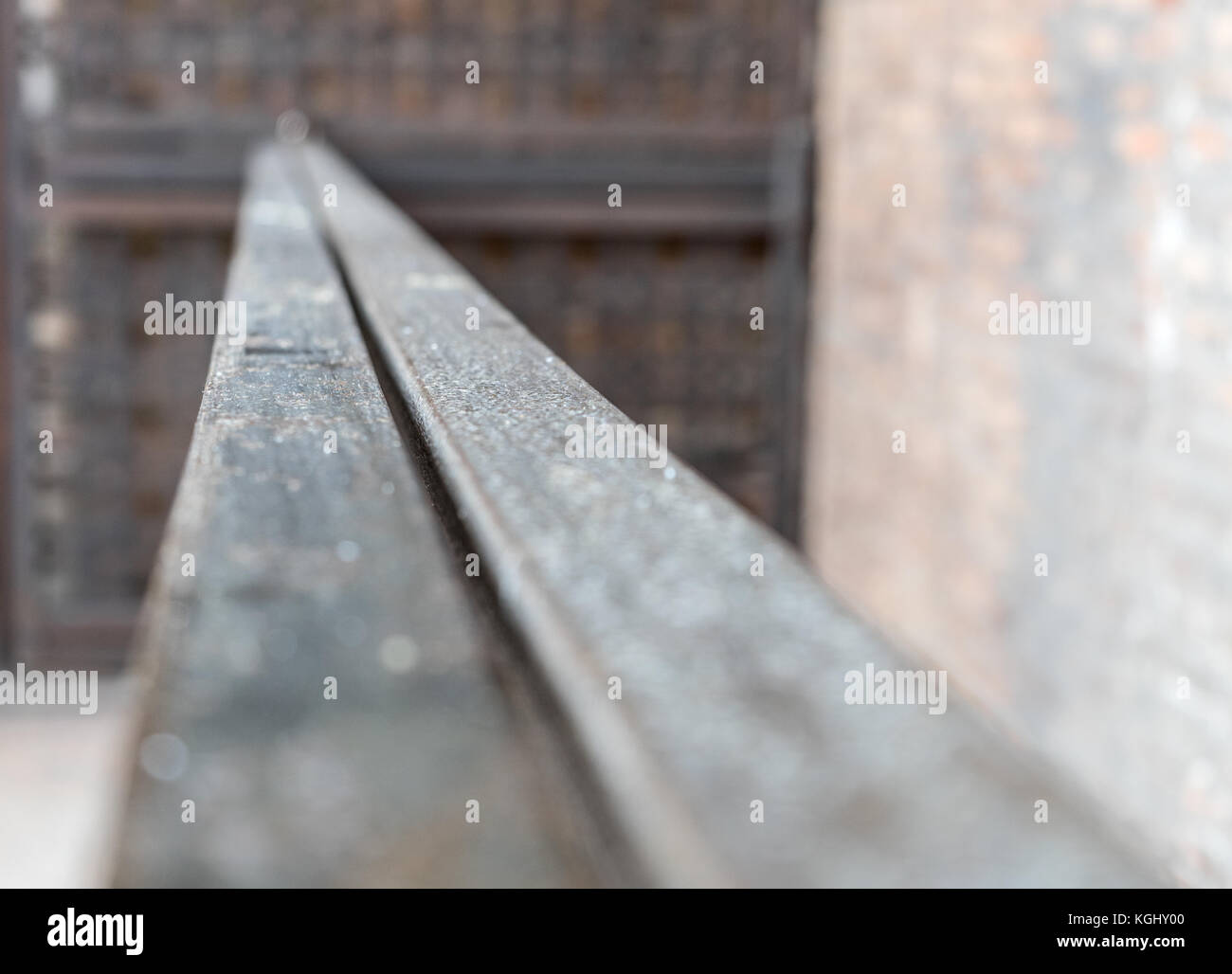 Old metal railing in front of a wall Stock Photo
