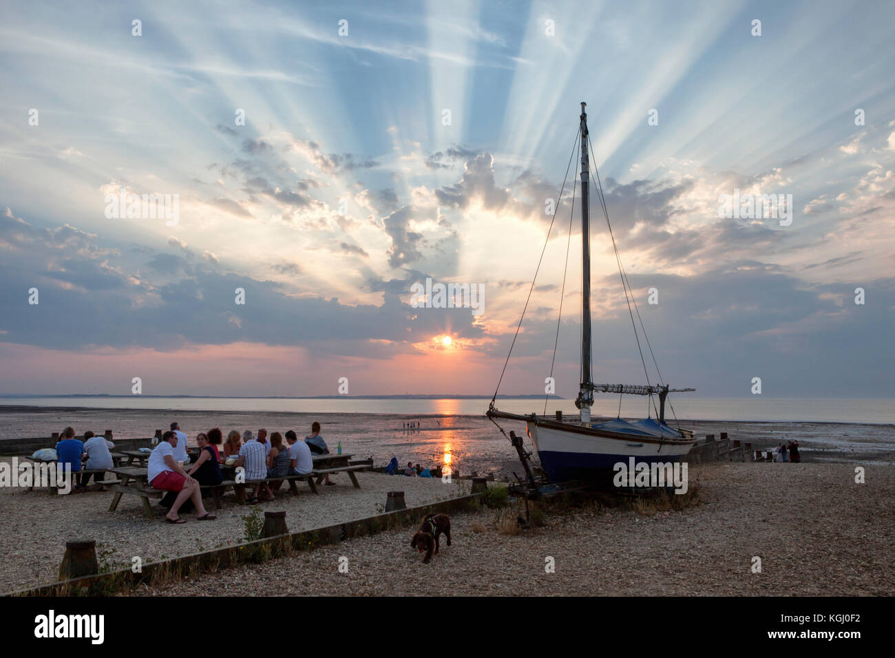 Dramatic crepuscular rays at sunset seen from West Beach, Whitstable, Kent, UK looking across to the Isle of Sheppey. Stock Photo
