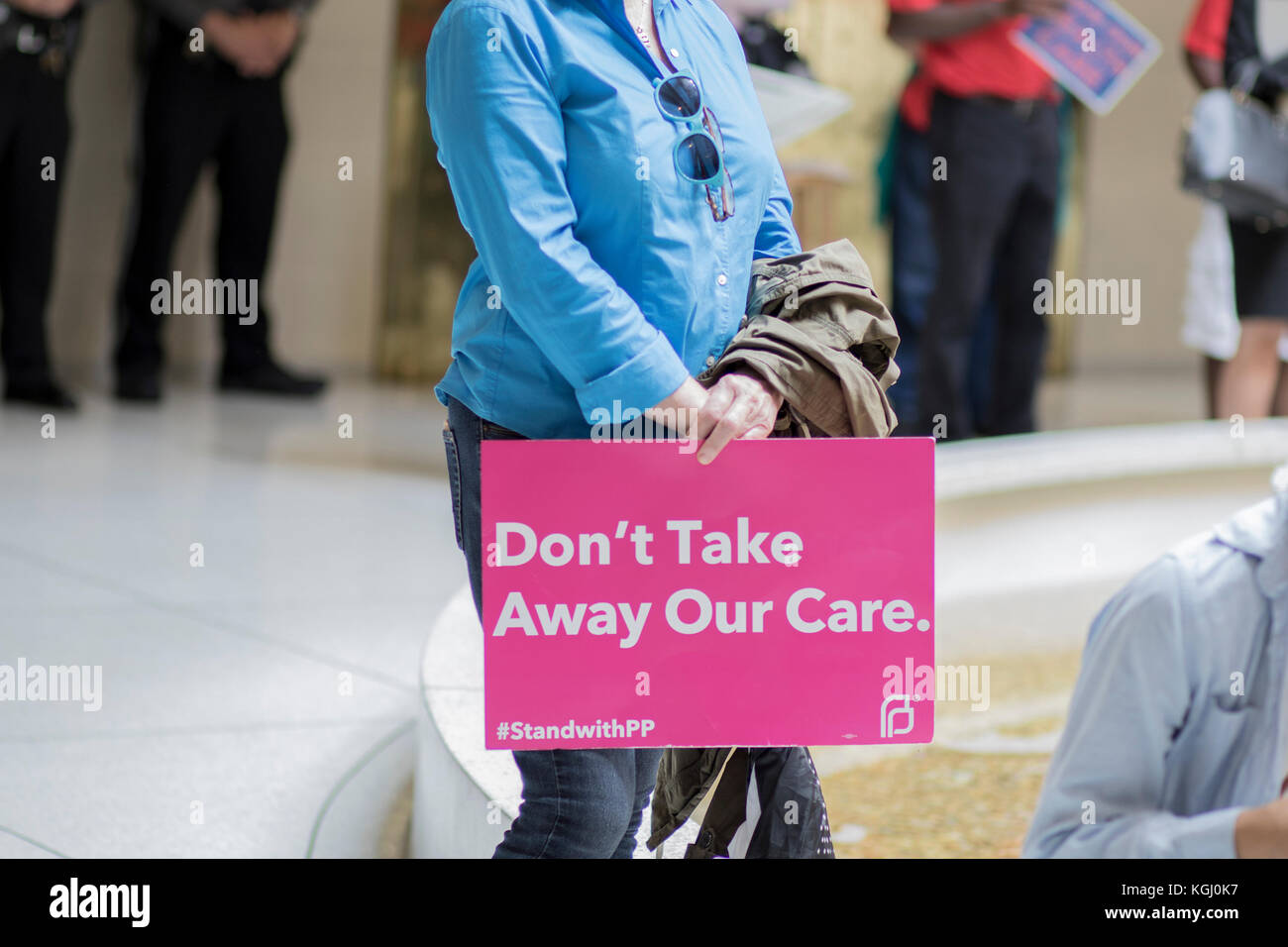Activist holding sign at healthcare protest Stock Photo