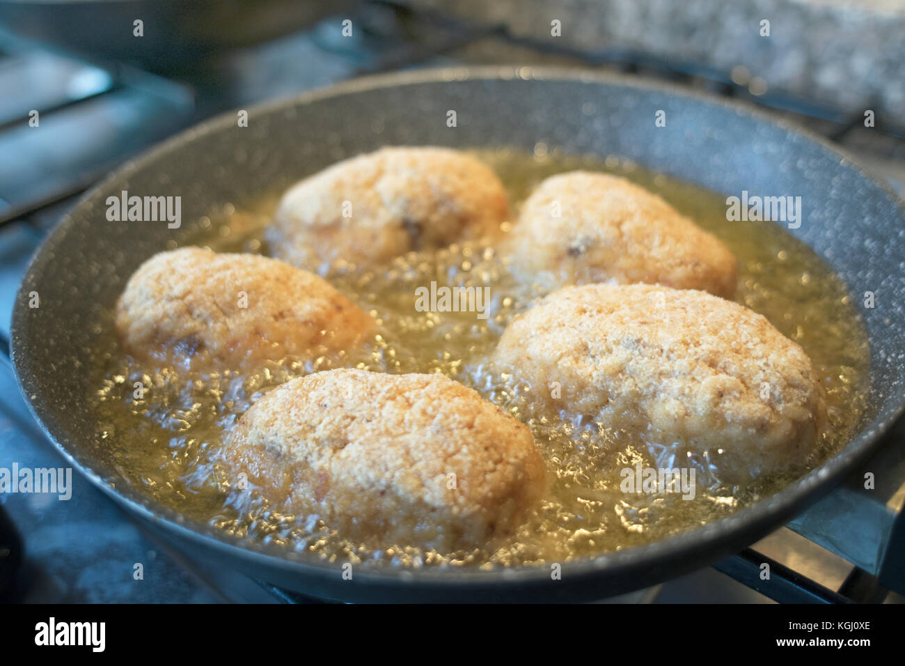 Rice Croquant sicilian rice croquettes frying in pan with boiling oil Stock Photo - Alamy