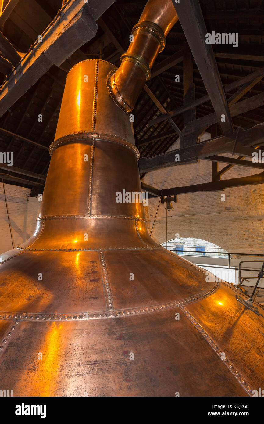 An Irish copper pot still used in the production of Irish whisky. A still is an apparatus used to distill fermented grain mash by heating to selective Stock Photo
