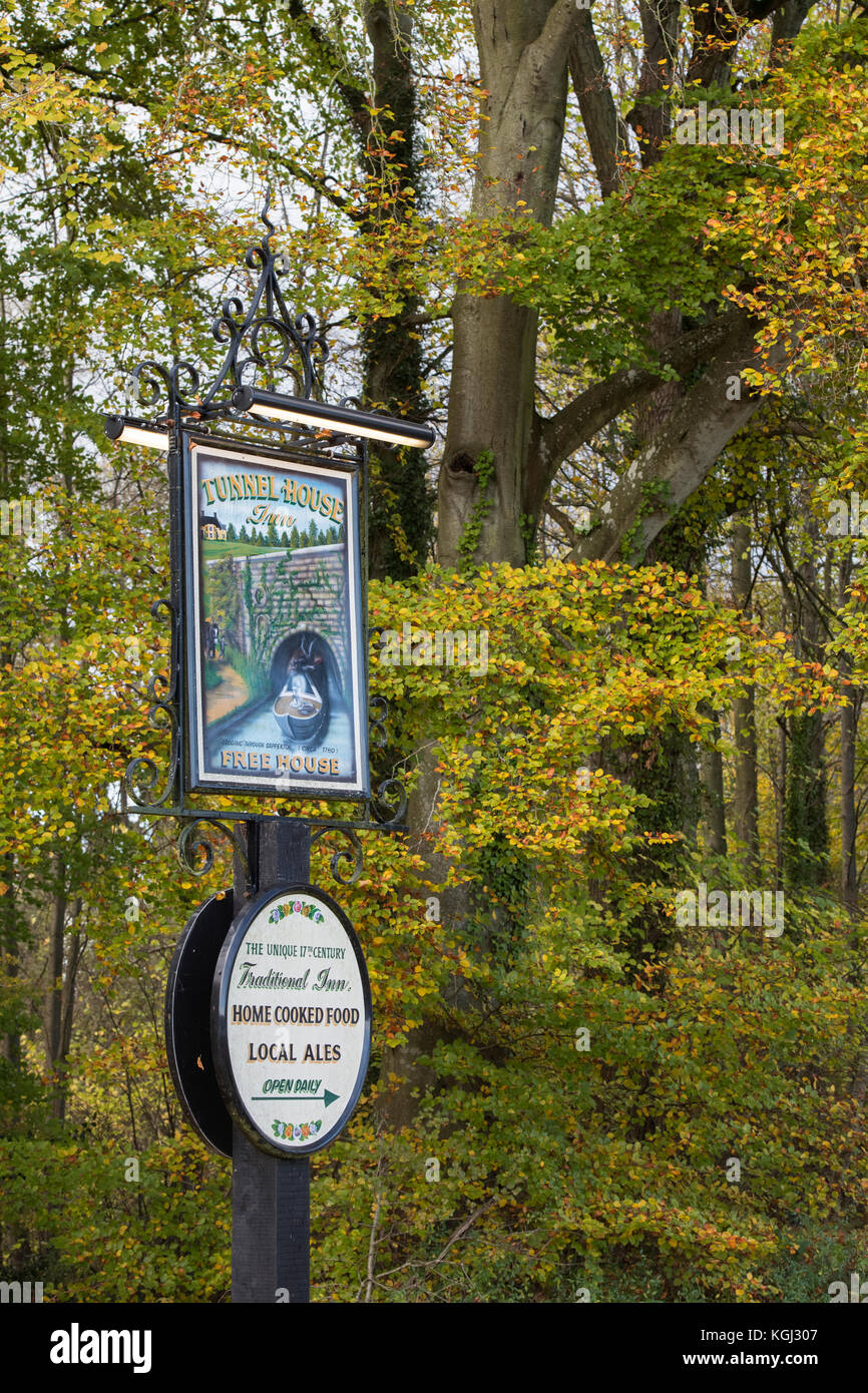 The Tunnel Inn pub sign next to Sapperton Canal Tunnel in autumn. Coates, Cirencester, Gloucestershire, UK Stock Photo