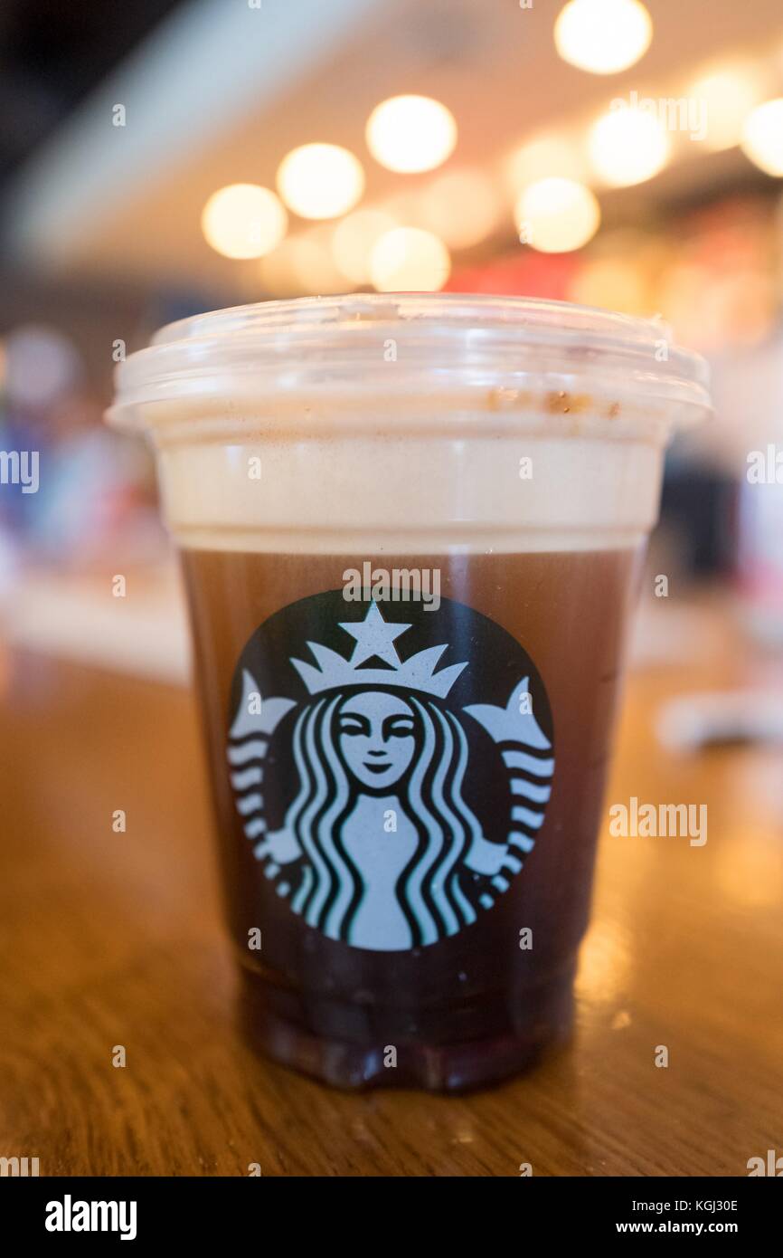 Close-up of a Nitro Freddo coffee drink, a cold brew coffee from Starbucks, served on draft using compressed nitrogen, with a topping of cold cream and caramel, introduced in select markets in 2017, on a light wooden surface, Silicon Valley, Palo Alto, California, September 20, 2017. () Stock Photo