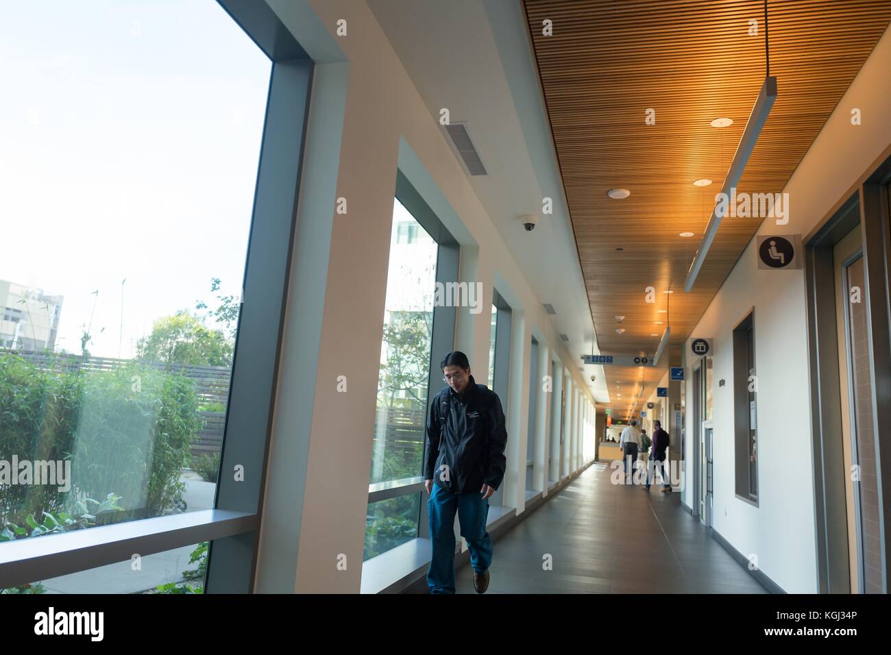 People walk through a corridor at the Mission Bay campus of the University of California San Francisco (UCSF) medical center in San Francisco, California, September 29, 2017. () Stock Photo