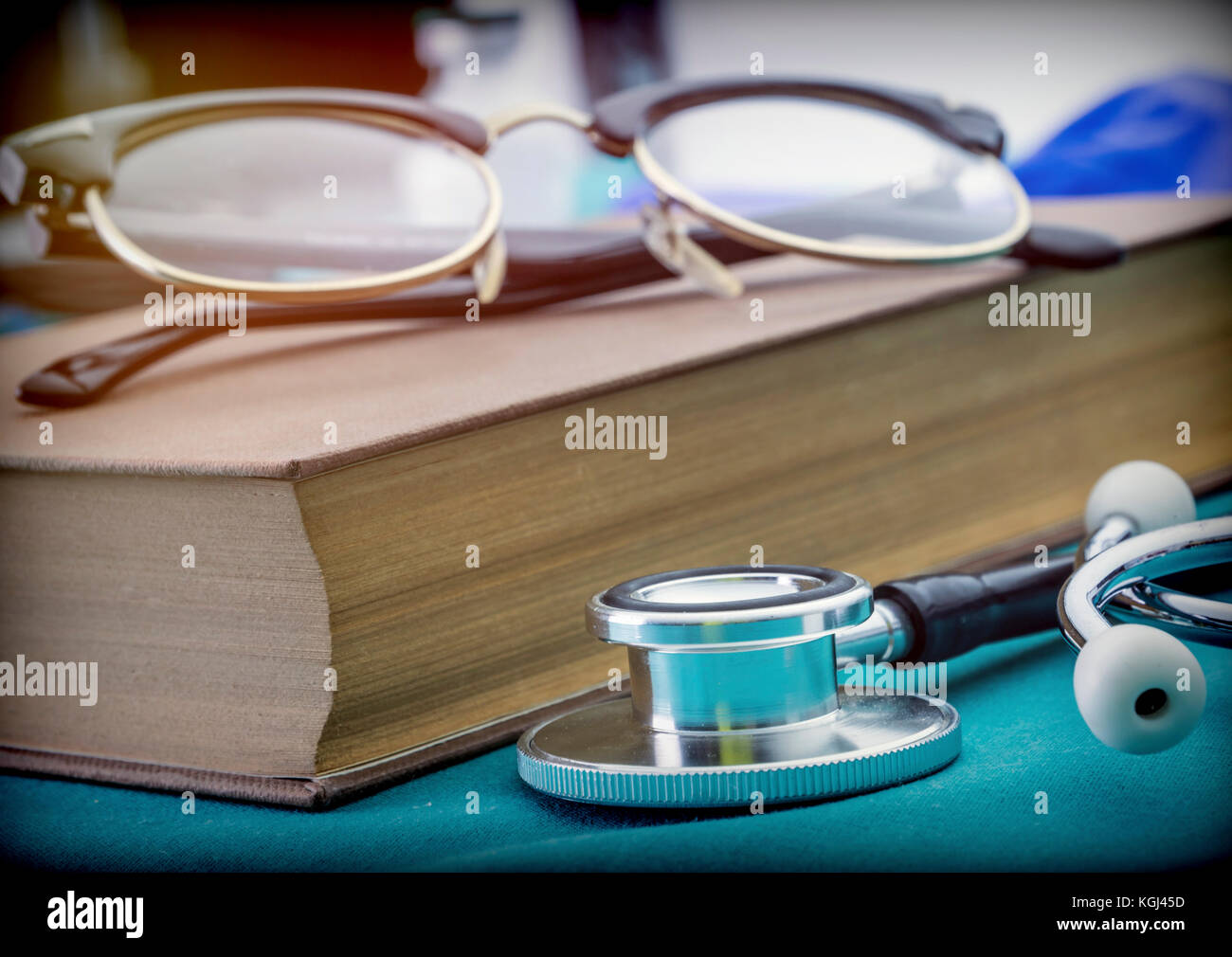 Medicine books next to a stethoscope and glasses, conceptual image Stock Photo