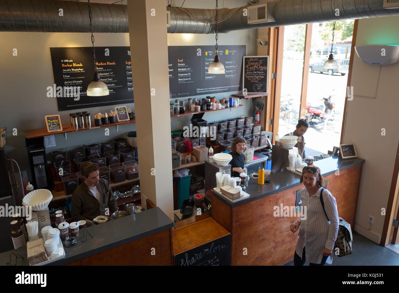 Overhead view of baristas preparing coffee and customers shopping at Philz Coffee, a popular California-based pour over artisan coffee chain in the Gourmet Ghetto (North Shattuck) neighborhood of Berkeley, California, October 6, 2017. () Stock Photo
