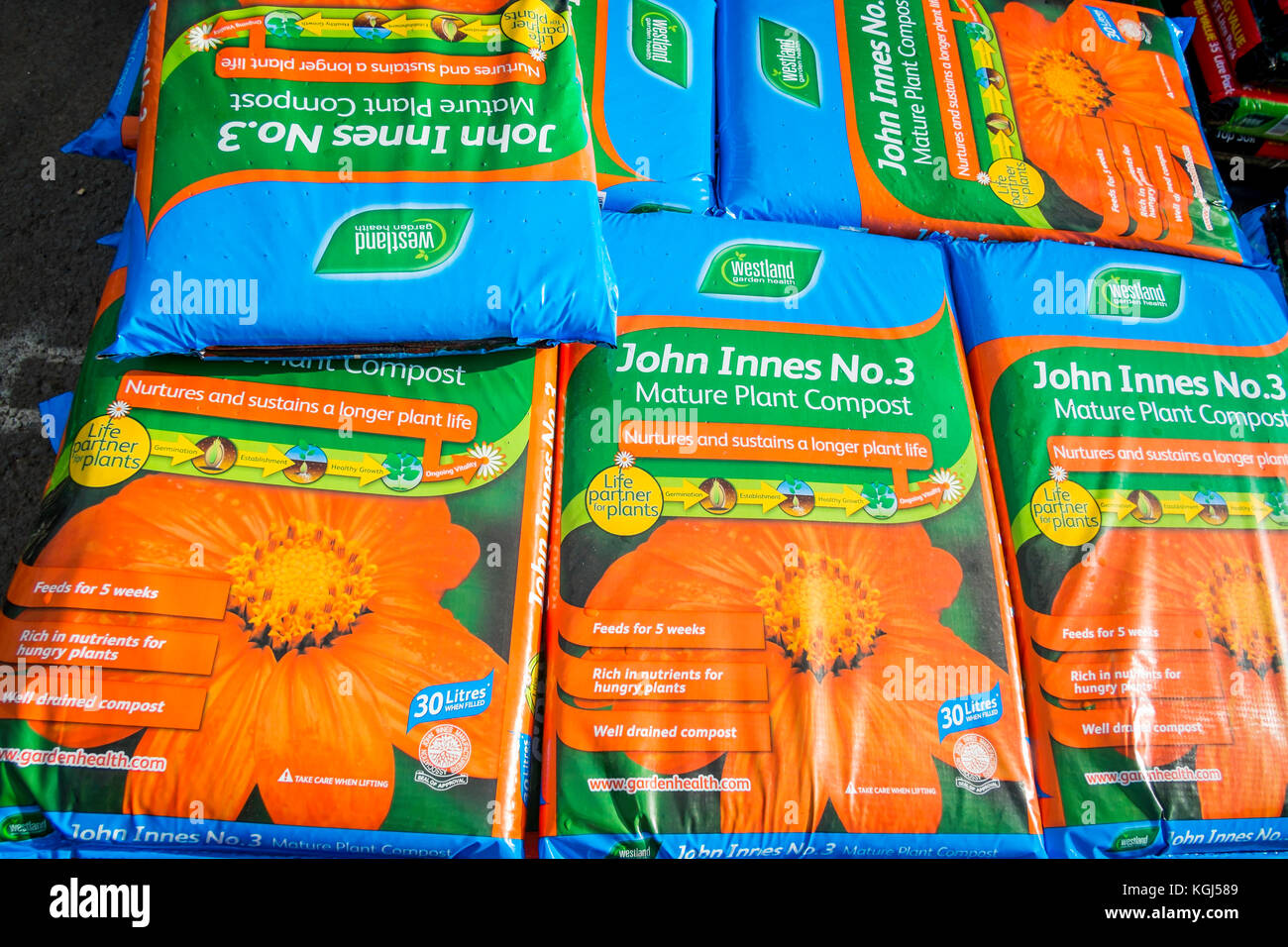 A stack of John Innes No. 3 Mature Plant Compost in a garden centre