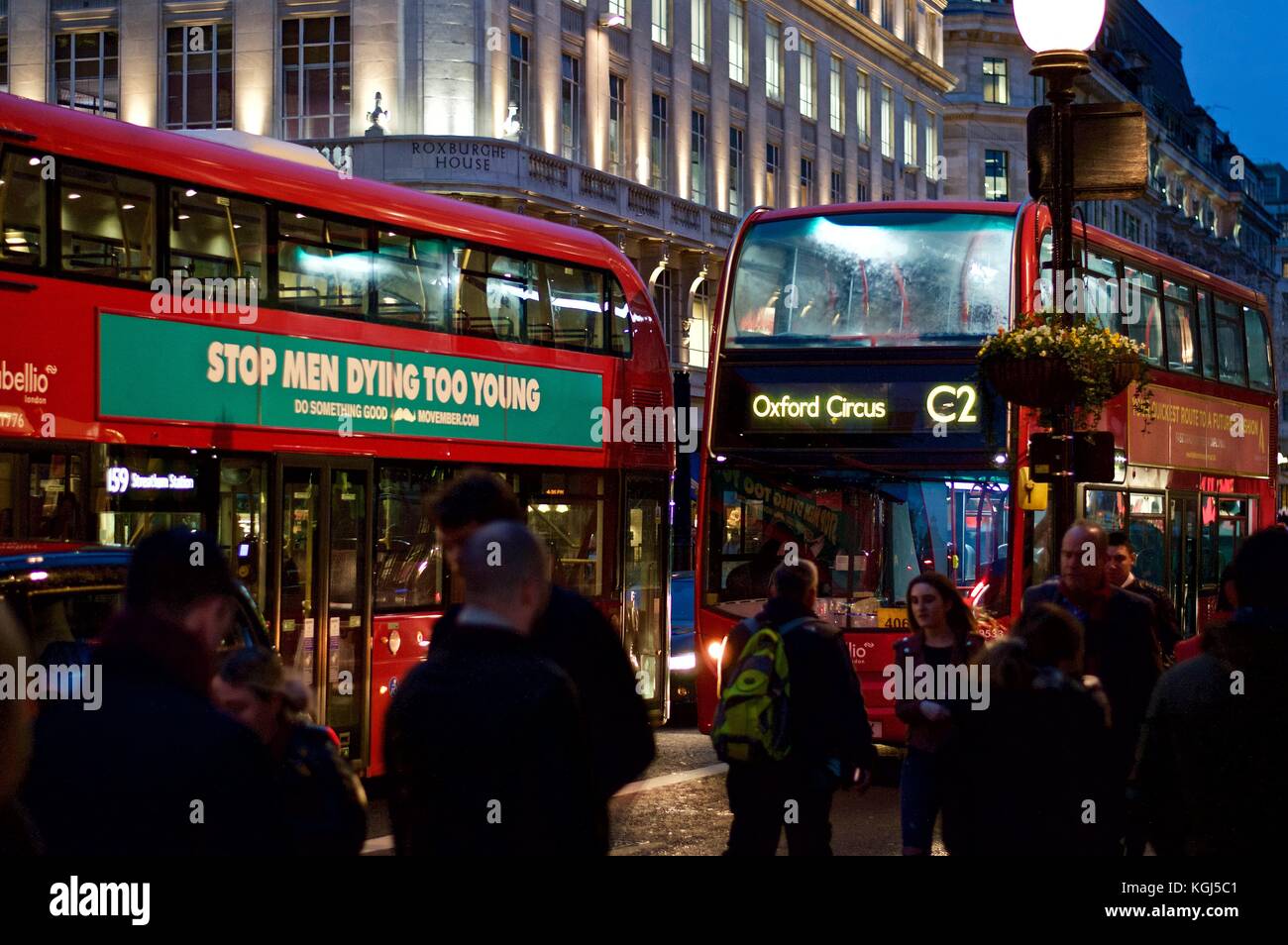C2 Bus to Oxford Circus behind another bus with prostate cancer advert, Regent Street, London, UK, 2017 Stock Photo
