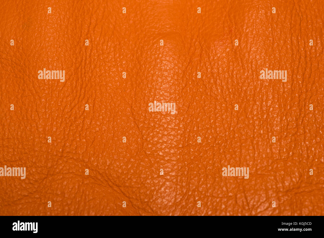 Orange leather showing surface details and creases. Stock Photo