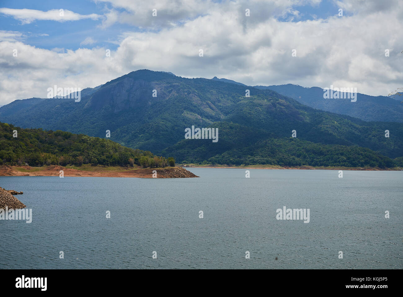 drizzling rain in the reservoir - blue sky over the river- bridge in the water -Kerala Stock Photo