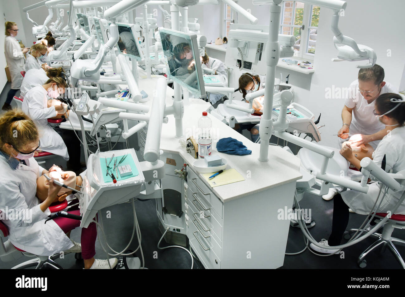 Fifth semester dentistry students from the School of Medicine of Martin Luther University Halle-Wittenberg grinding practice teeth on state-of-the-art dental simulation units in Halle (Saale), Germany, 23 October 2017. Students are able to work on practice heads with original equipment and drill working procedures in this training hall. The dental clinic, which also counts with a room for treatment by students, was delivered to the School of Medicine as one of Germany's most modern dental clinics in September. About 240 students arre currently receiving here their training. Photo: Waltraud Gru Stock Photo
