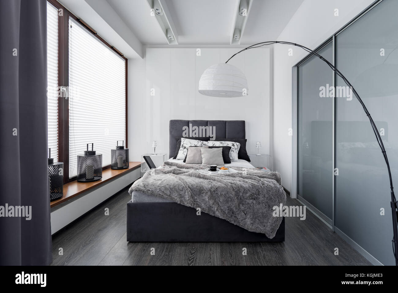 Modern bedroom with floor lamp, wardrobe and double bed Stock Photo Alamy