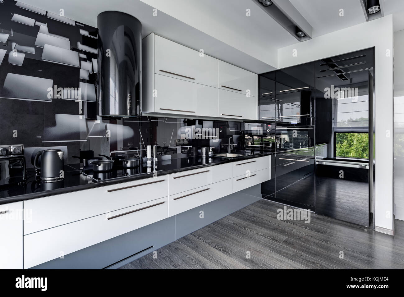Contemporary And Elegant Kitchen With White Cupboards And Black Wall Stock Photo Alamy