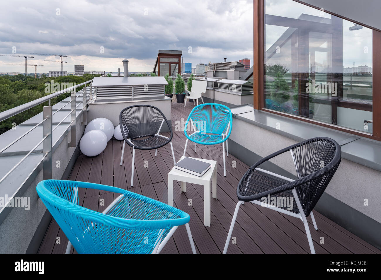 Perfect roof terrace with modern chairs and wooden decking Stock Photo