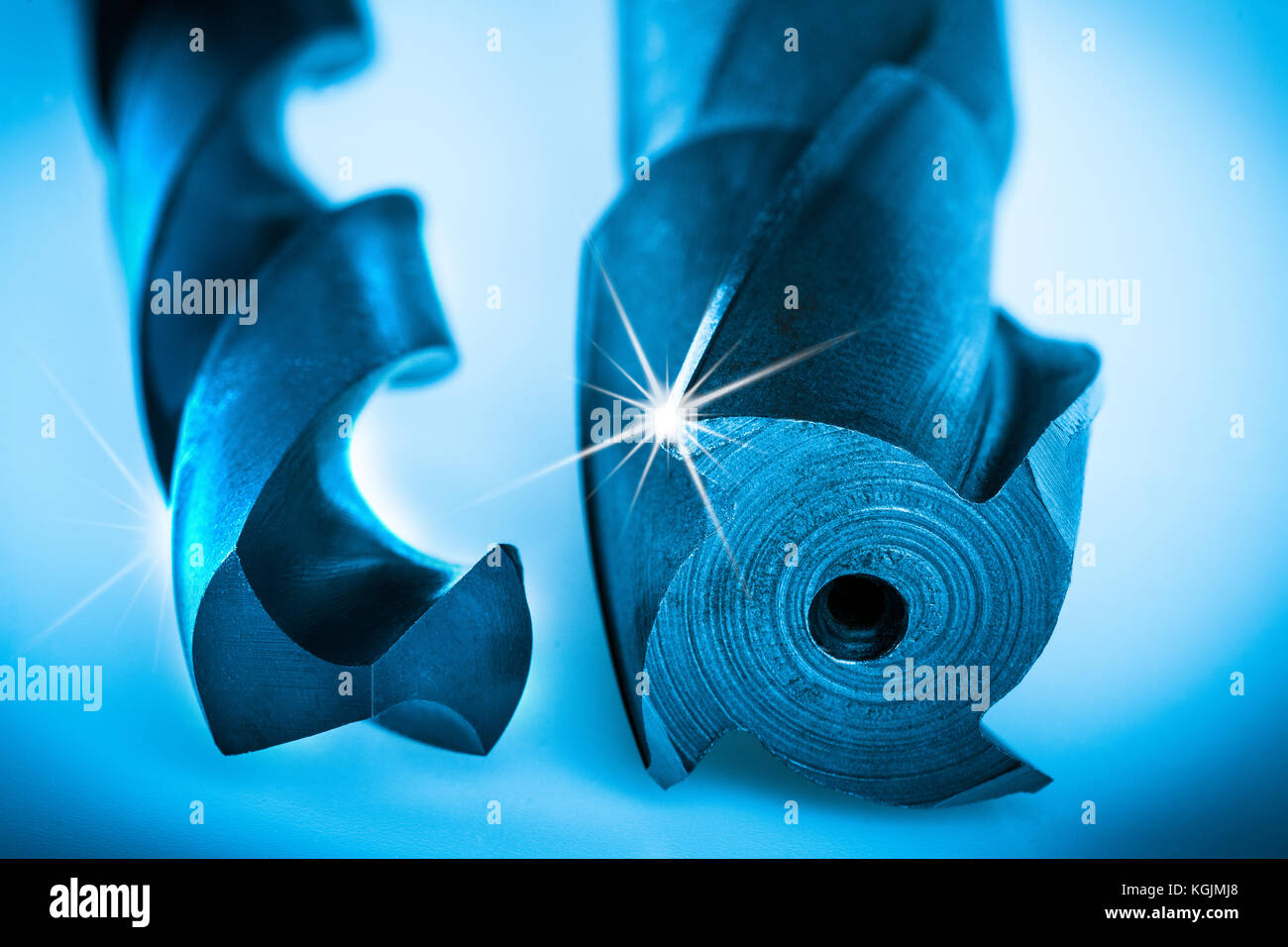 Detail of cutting tools for making geometrically accurate holes. Beautiful drill tools with spiral grooving in blue color with rays on cutting edge Stock Photo