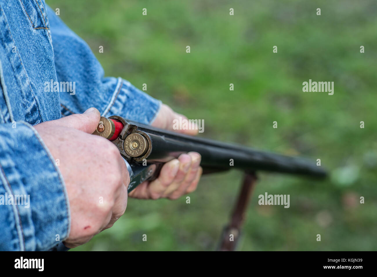 Closeup of a man loading a dubble barrel shotgun. Stock Photo