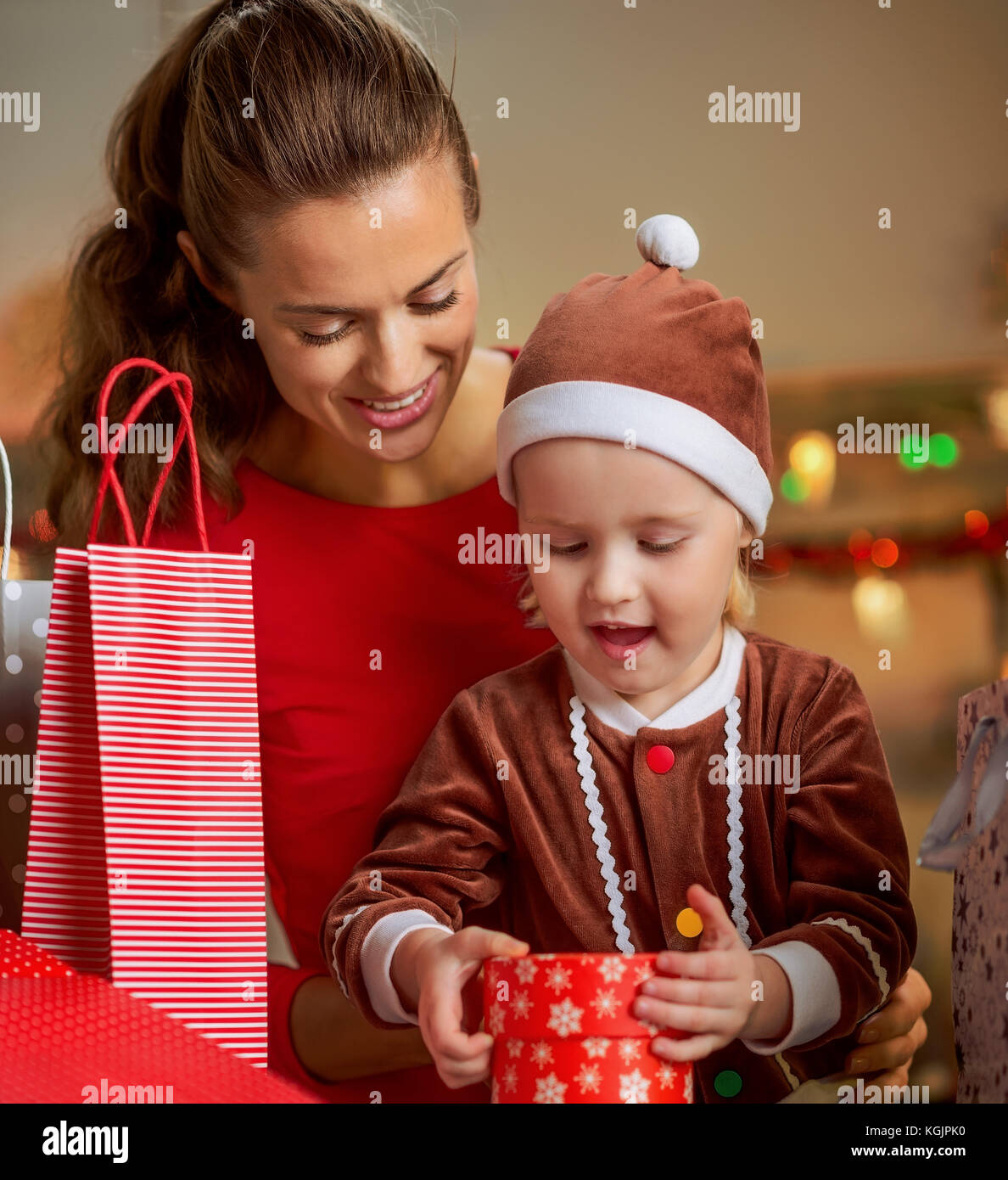 Portrait of happy mother and baby opening christmas present box Stock