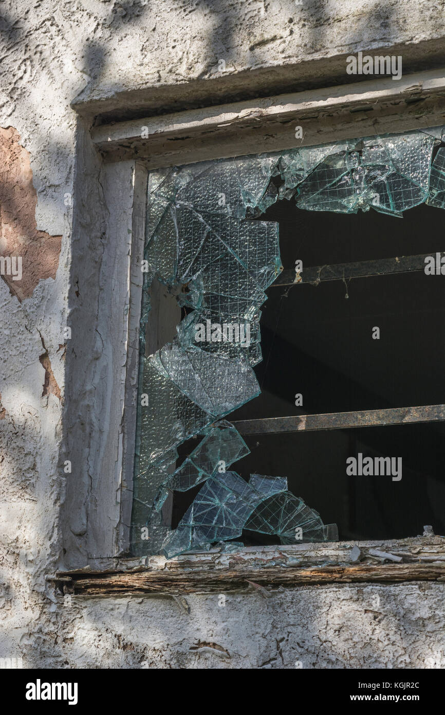 Broken / smashed reinforced glass window. Metaphor for vandalism, shattered dreams, broken glass