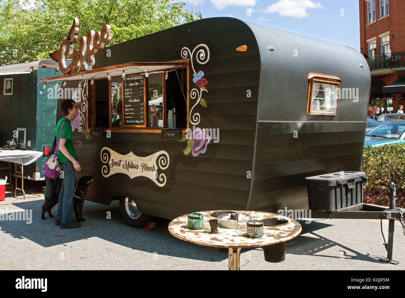 Suwanee, GA, USA - May 6, 2017:  A man orders coffee from a coffee-themed food truck at Woofstock, a dog festival at Suwanee Town Center. Stock Photo