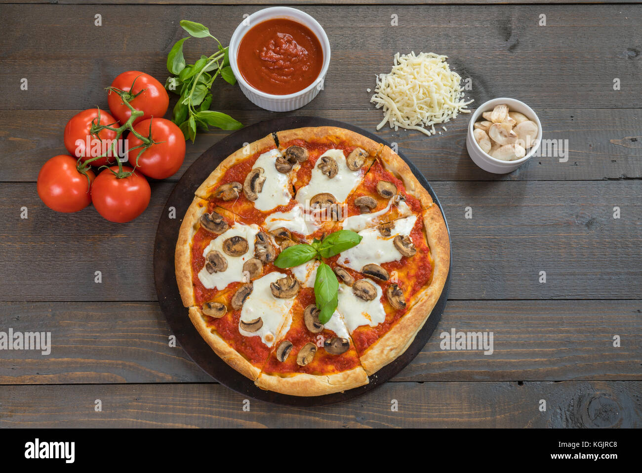 Fresh hot pizza on wood table with ingredients Stock Photo Alamy