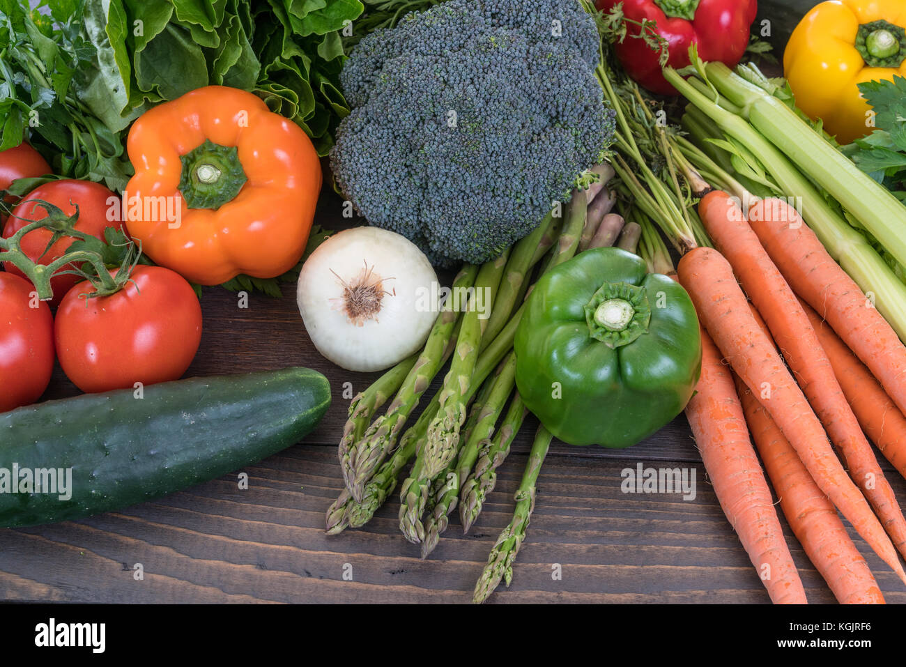 Assorted fresh raw vegetables on a rustic wood table Stock Photo - Alamy