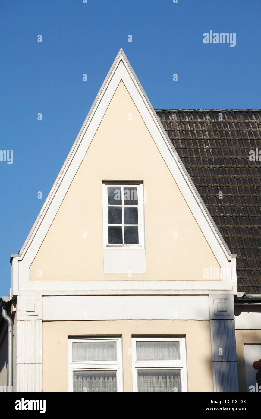 white roof window on an old house, roof gable Stock Photo