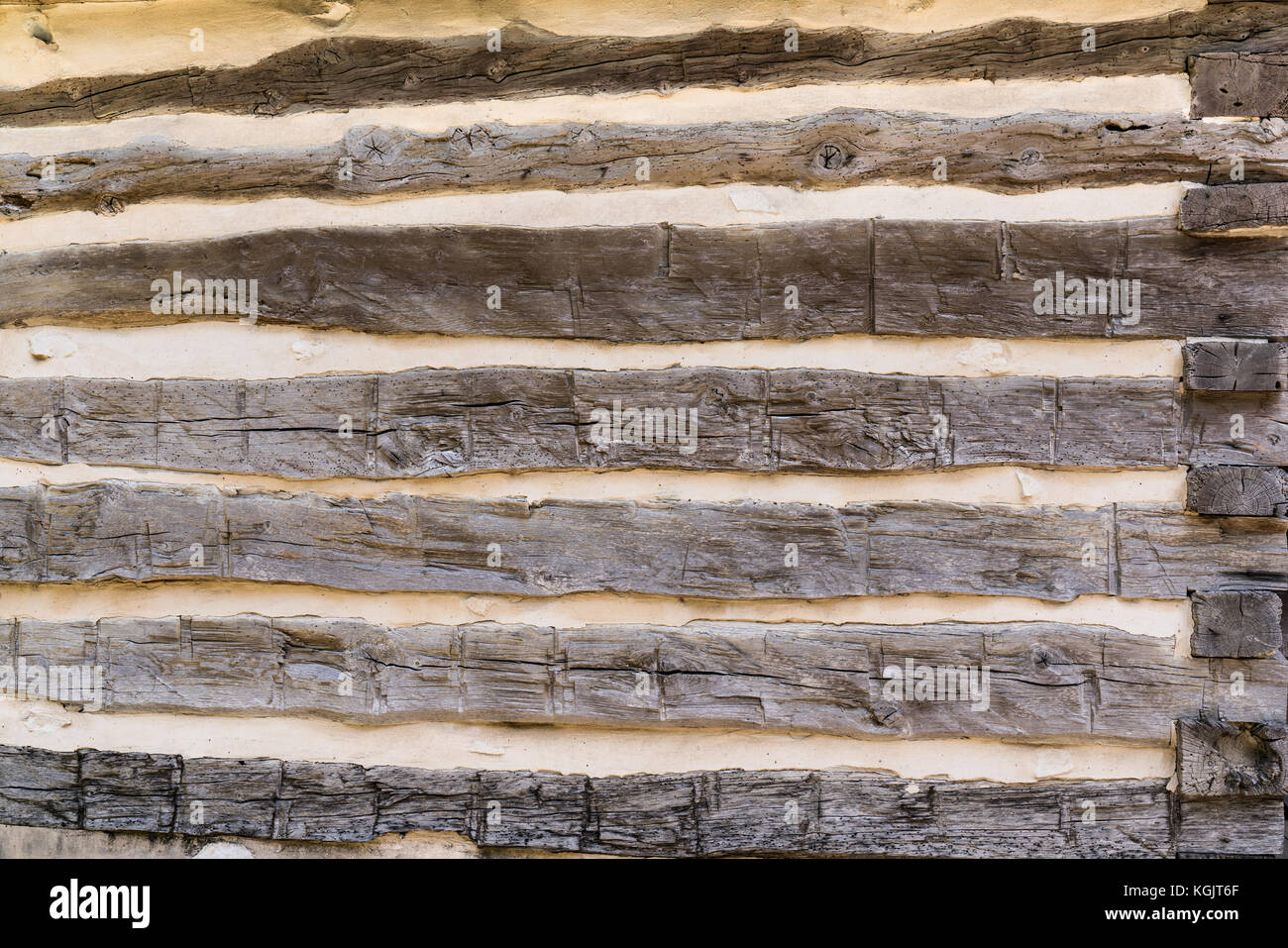 Old vintage hand hewn log house wall background Stock Photo