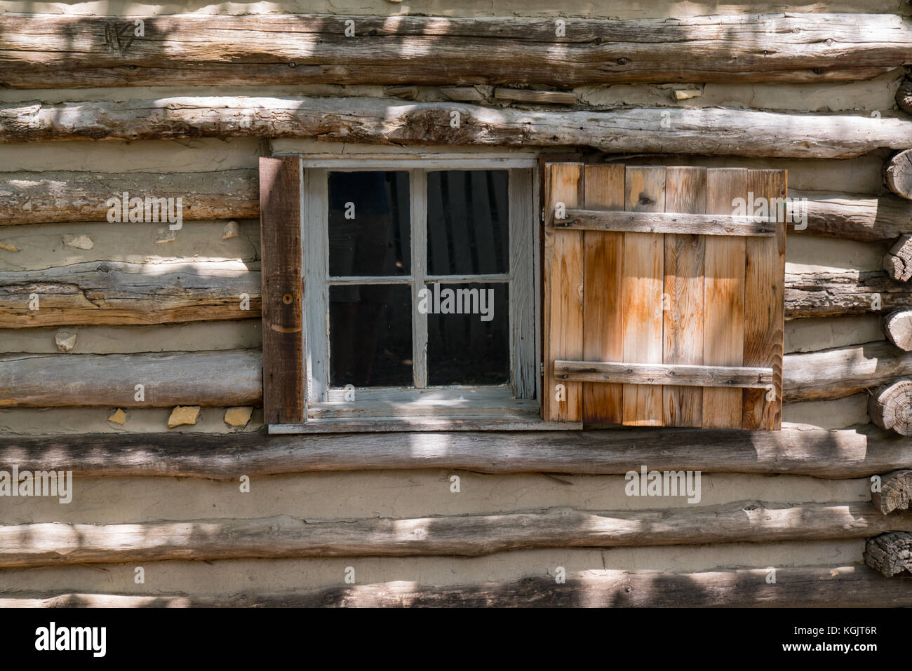 Old wooden log house window background Stock Photo