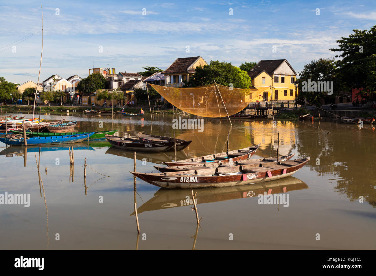 Early morning at Hoi An old town river canal. A hanging fishing net on display. Vietnam. Stock Photo