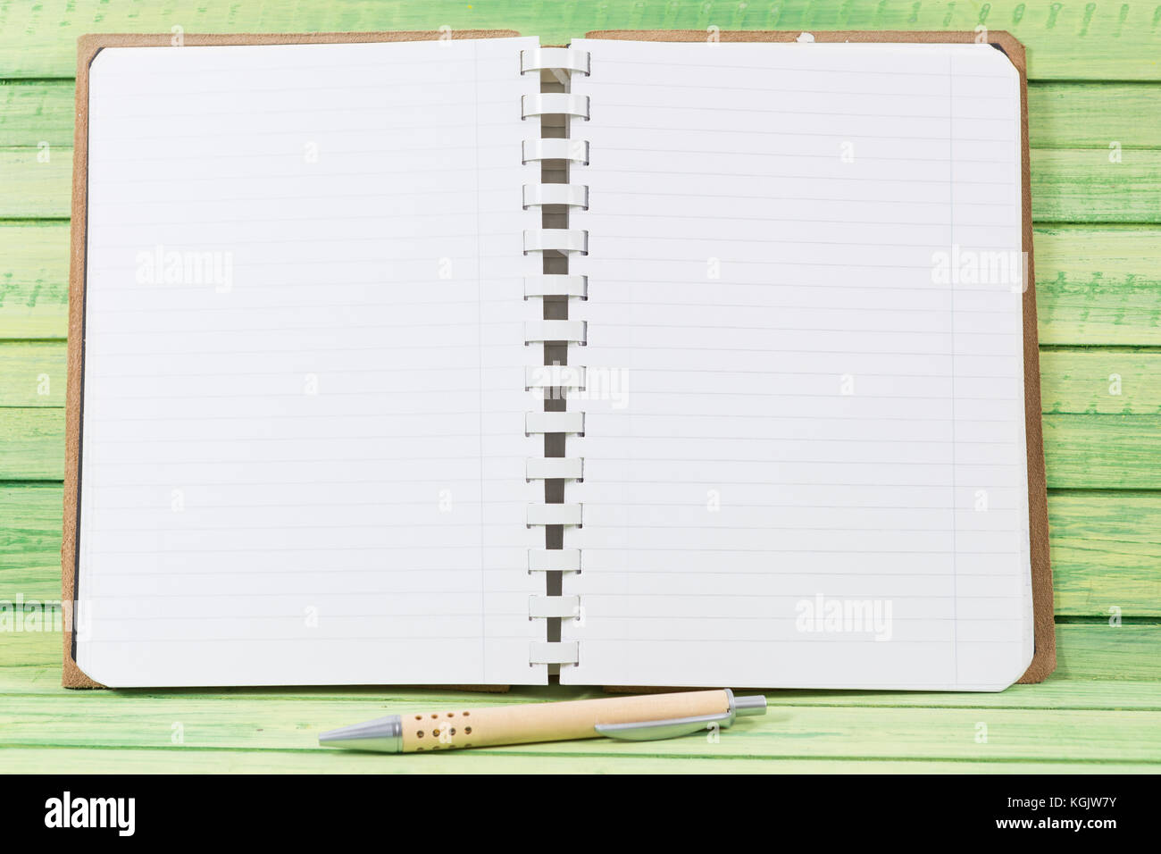 https://c8.alamy.com/comp/KGJW7Y/open-blank-notebook-with-pen-on-wooden-board-as-diary-or-journal-concept-KGJW7Y.jpg