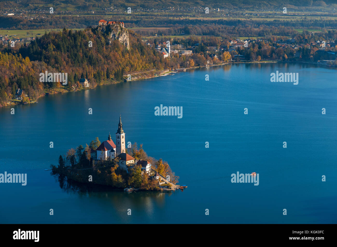 Bled, Slovenia - Sunrise at lake Bled taken from Osojnica viewpoint with traditional Pletna boat and Bled Castle at background at autumn Stock Photo