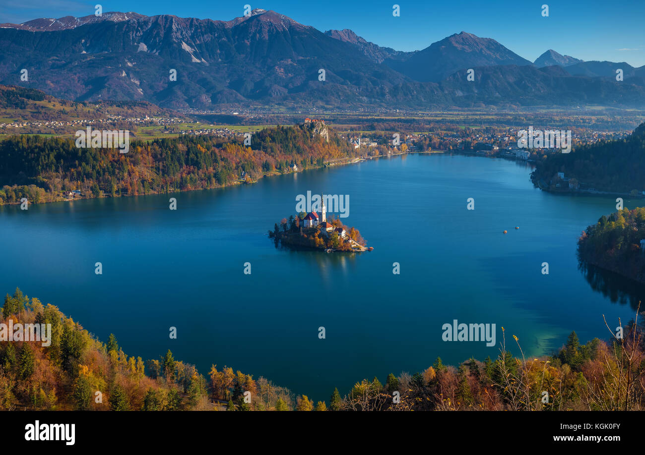 Bled, Slovenia - Sunrise at lake Bled taken from Osojnica viewpoint with traditional Pletna boats and Bled Castle at background at autumn Stock Photo