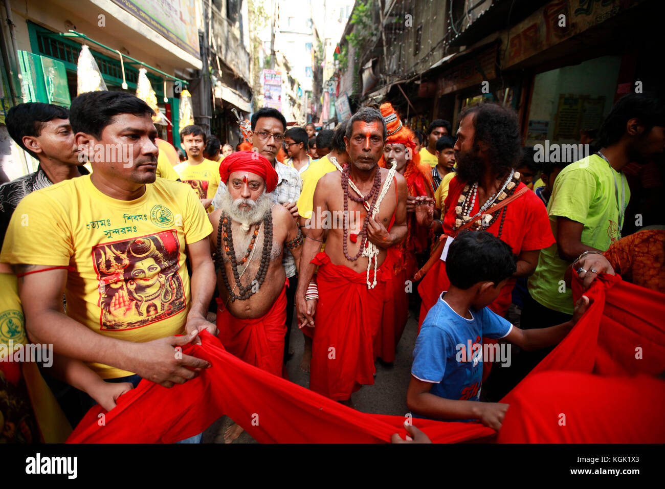 Bangladeshi Hindu people donate money as they take part in a ritual