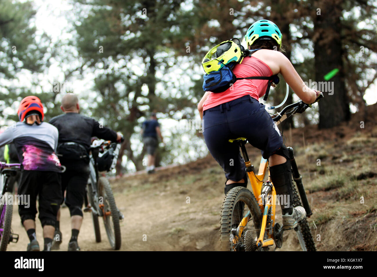 Horizontal photo of a female rider climbing a step climb on her ...