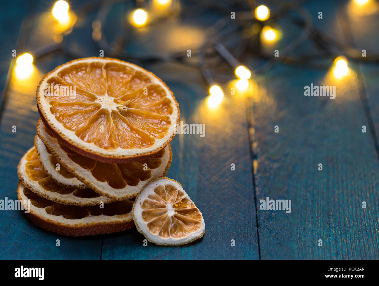 Dried oranges on petrol-colored wood. Stock Photo