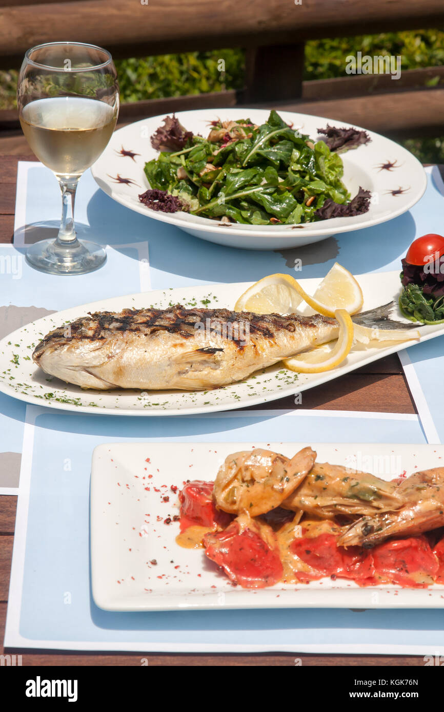 closeup of a healthy seafood on a table for two by the sea Stock Photo