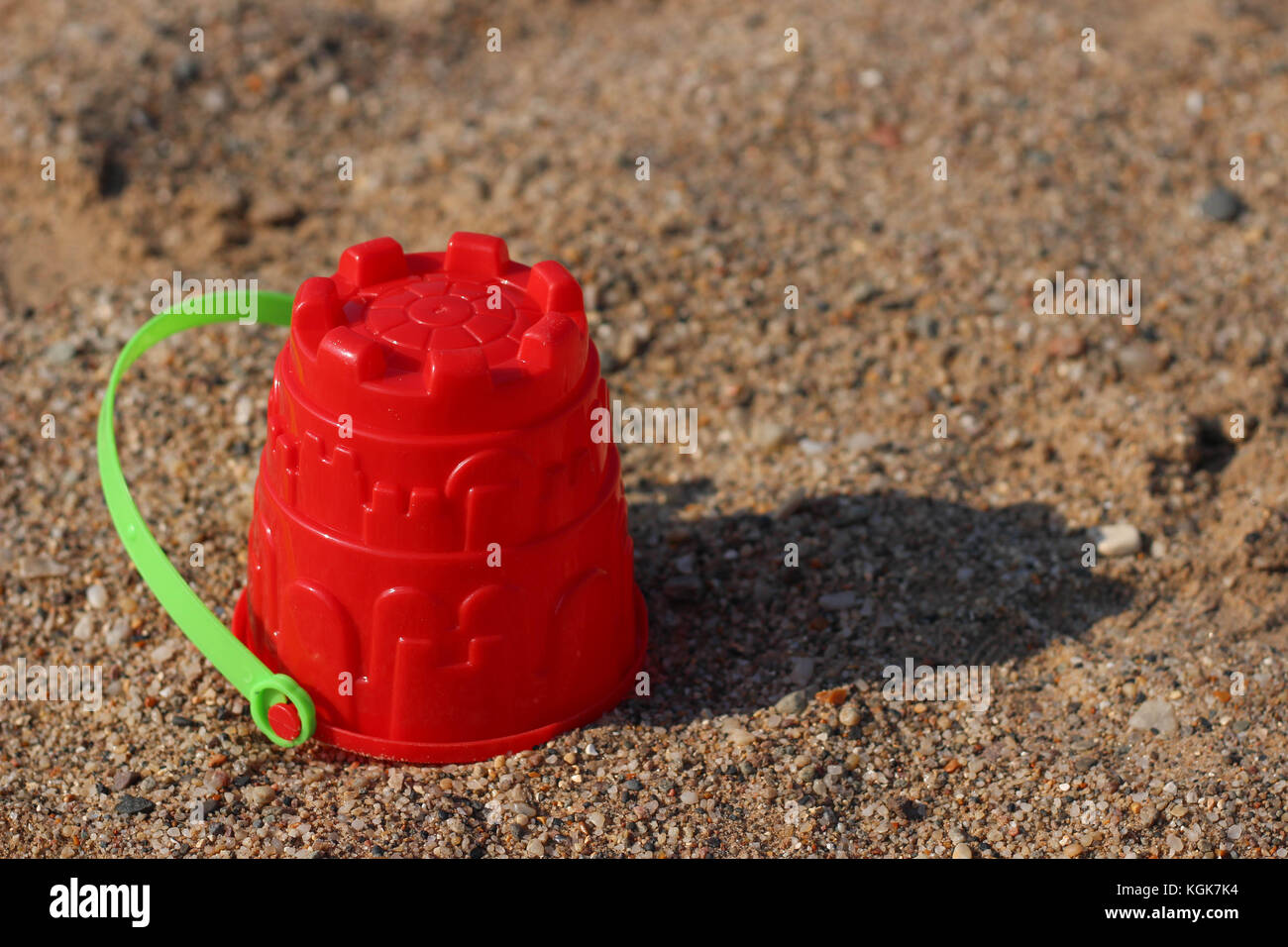 red sand bucket on the beach Stock Photo