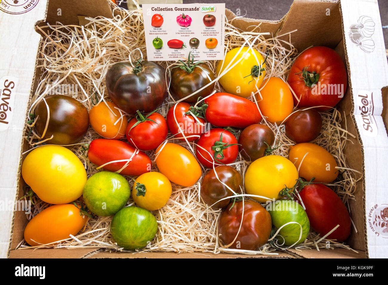 Coloured varieties of heritage tomatoes on French market stall. Stock Photo