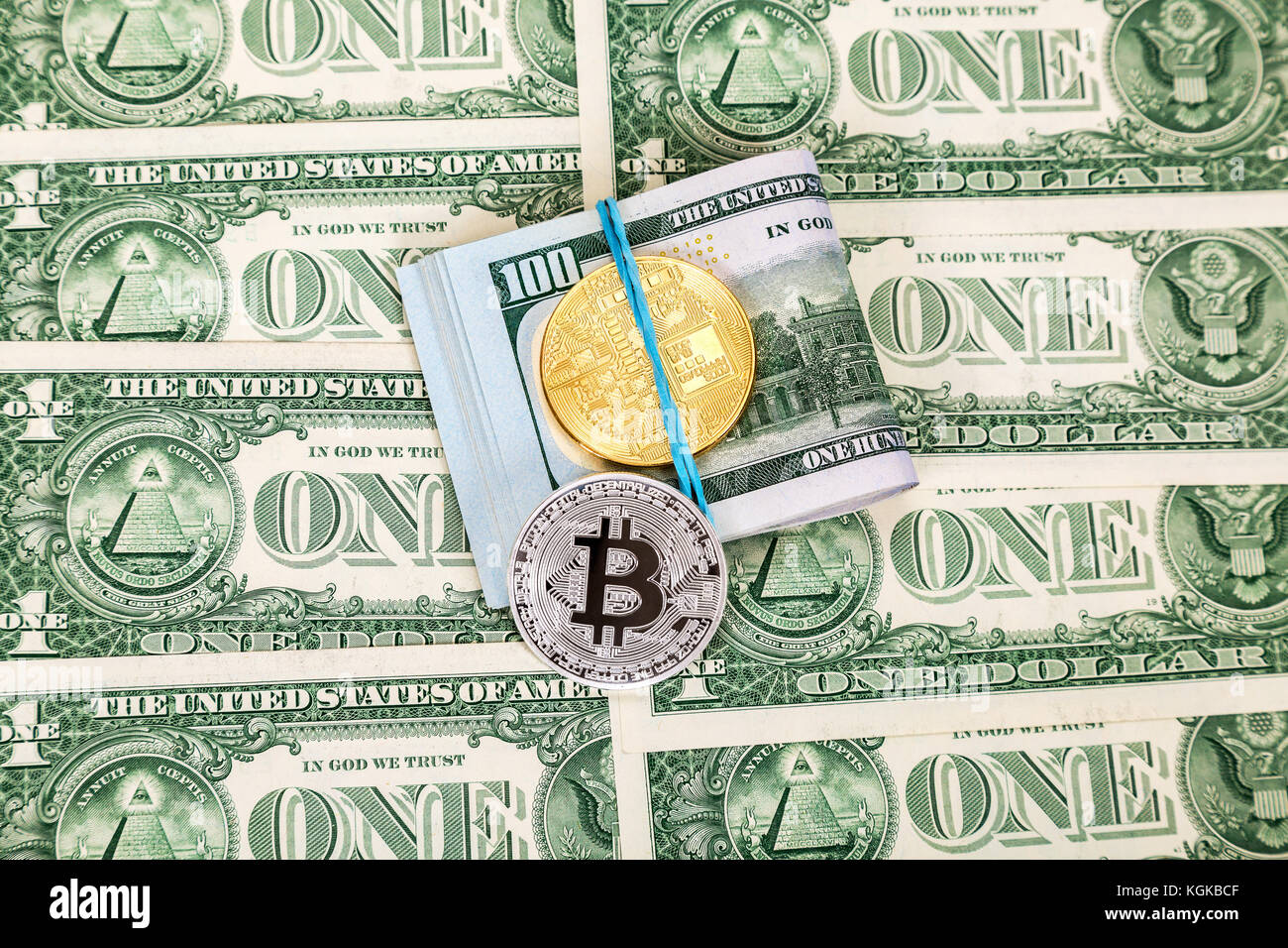 Folded american dollars and coins of cryptocurrency over dollar ...