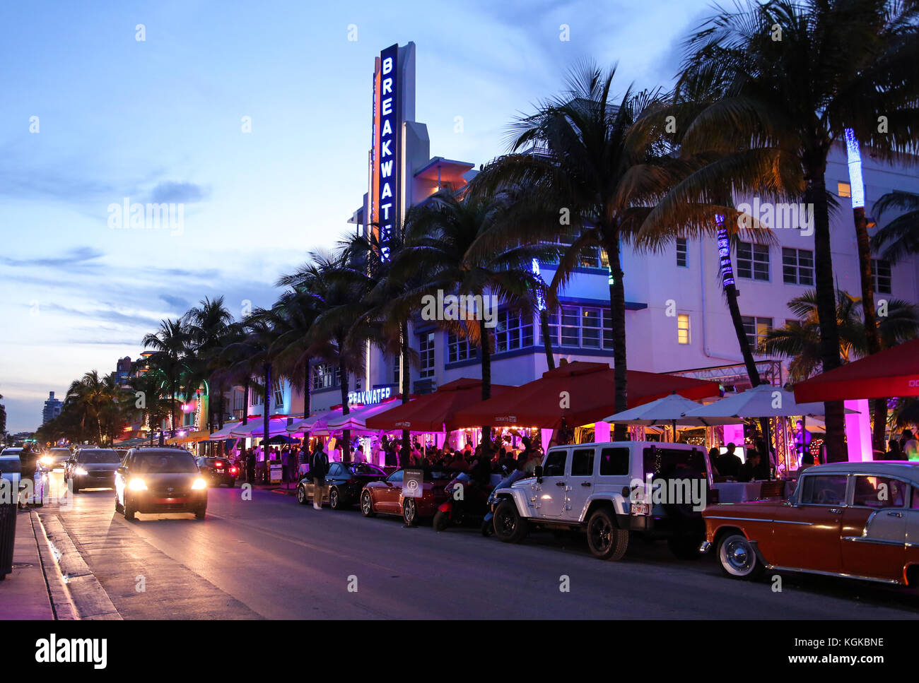 Cars and traffic in the evening on Ocean Drive in front of Breakwater Hotel and Art Deco buildings in South Beach, Miami, Florida, USA. Stock Photo