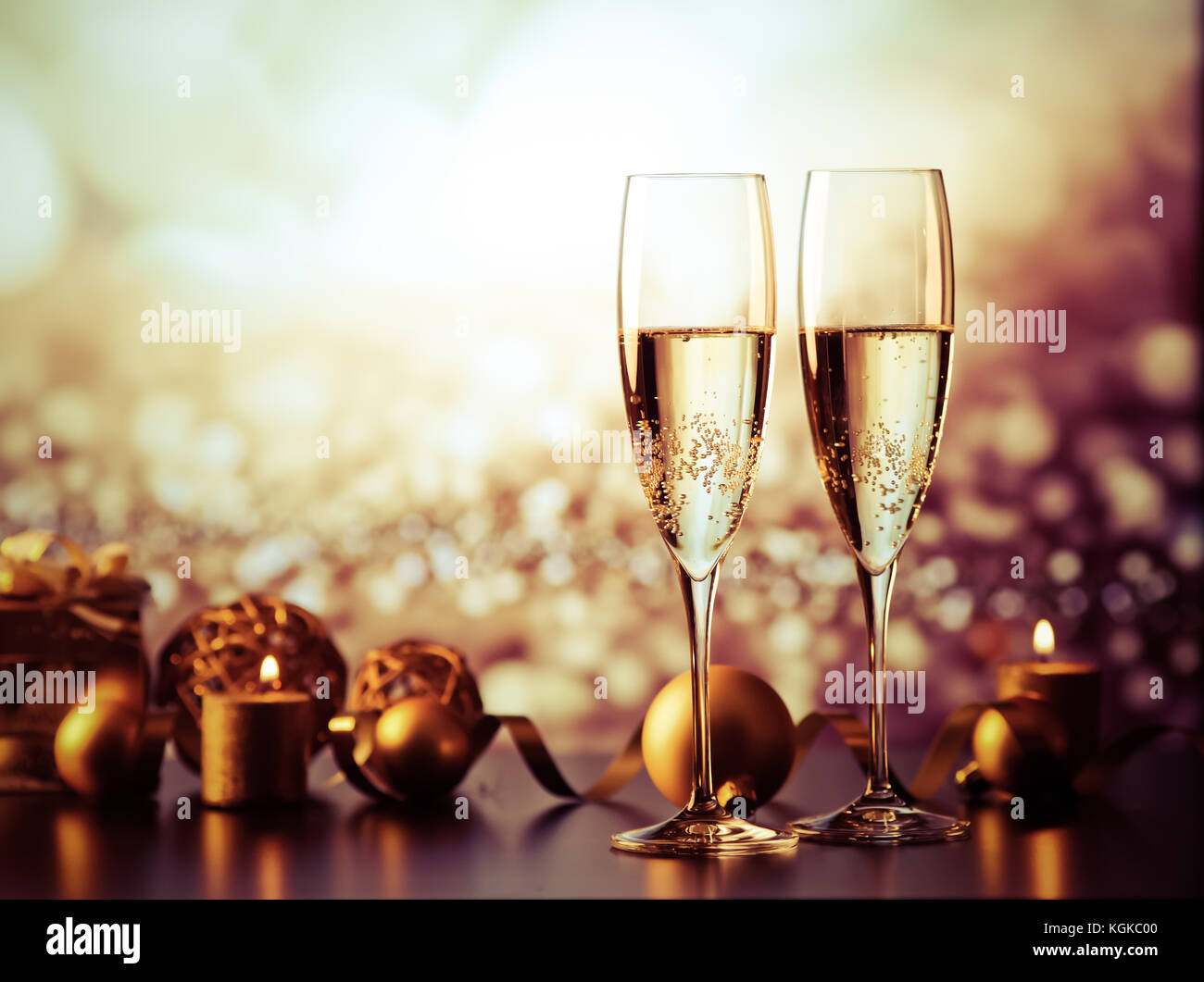 two champagne glasses against holiday lights and fireworks - new year ...
