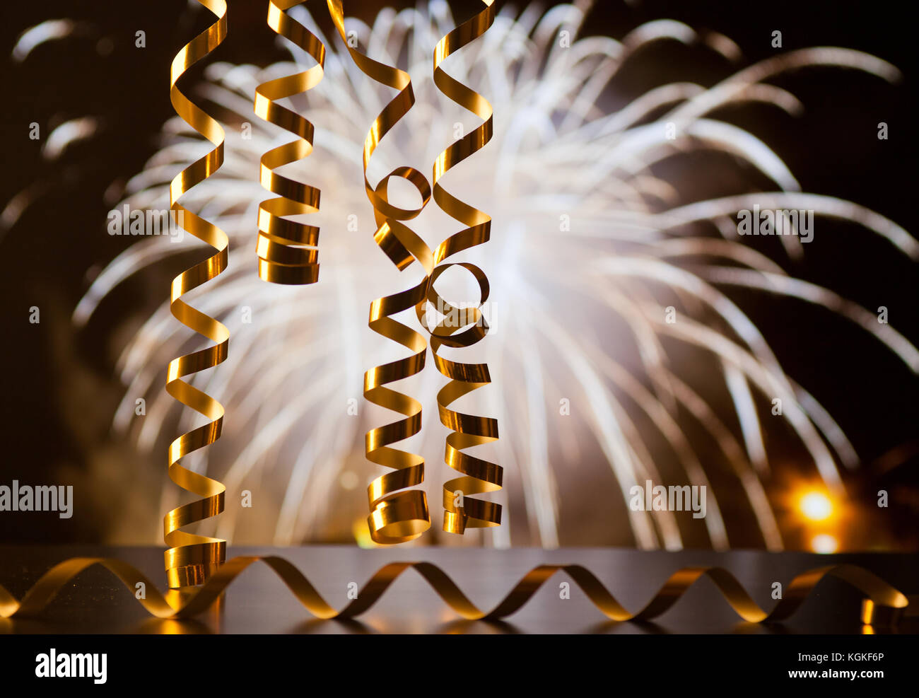 Making Ribbon Fireworks ribbons against fireworks - new year celebrations Stock Photo - Alamy