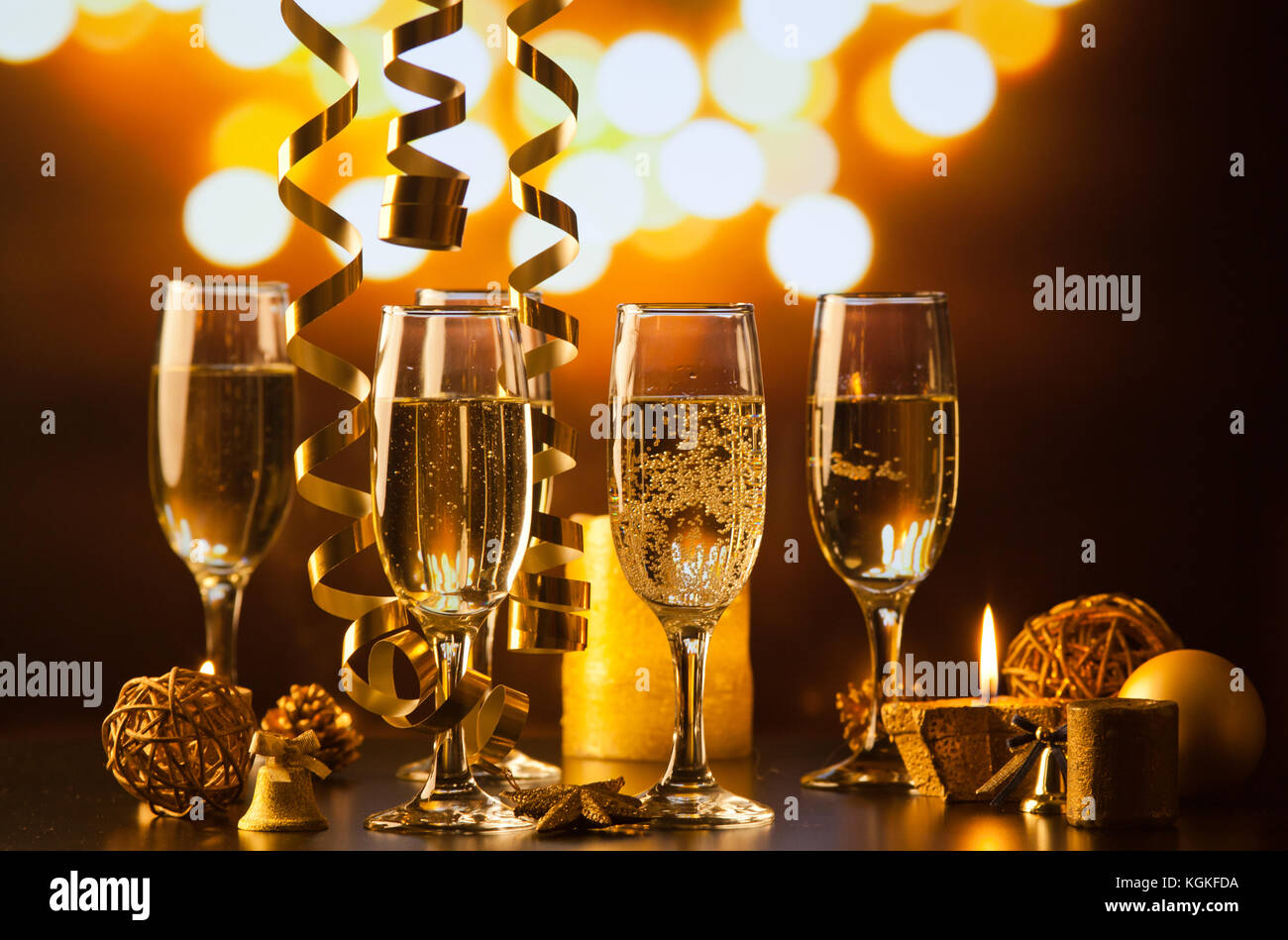 champagne glasses against holiday lights ready for New Year's eve party