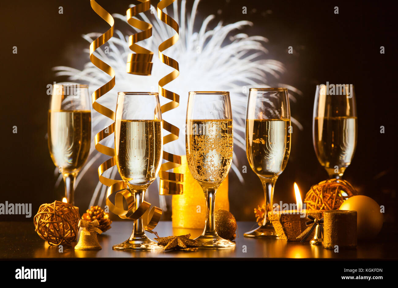 champagne glasses against holiday lights ready for New Year's eve party