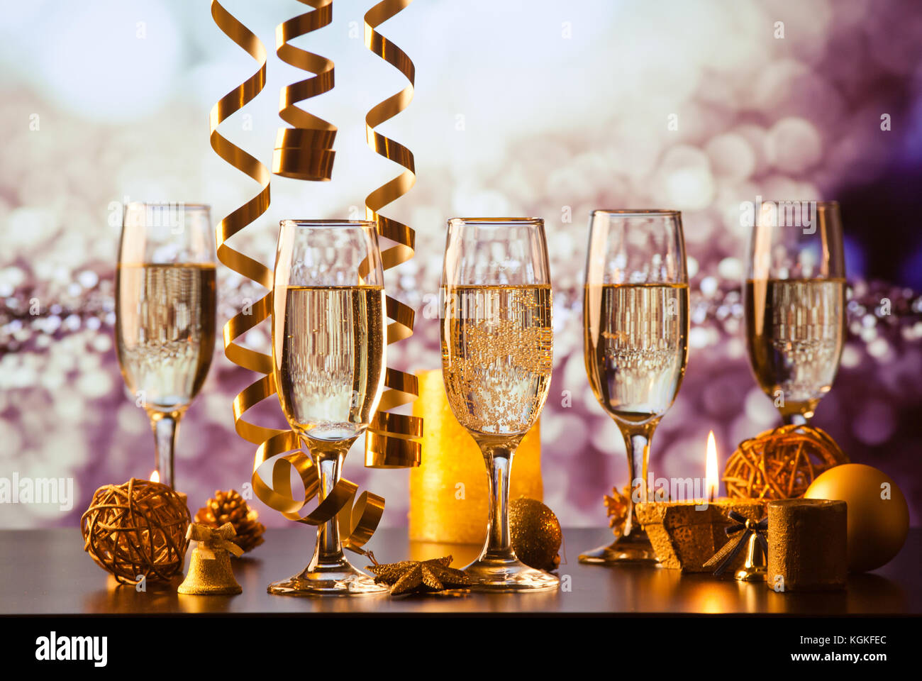 champagne glasses against holiday lights ready for New Year's eve party
