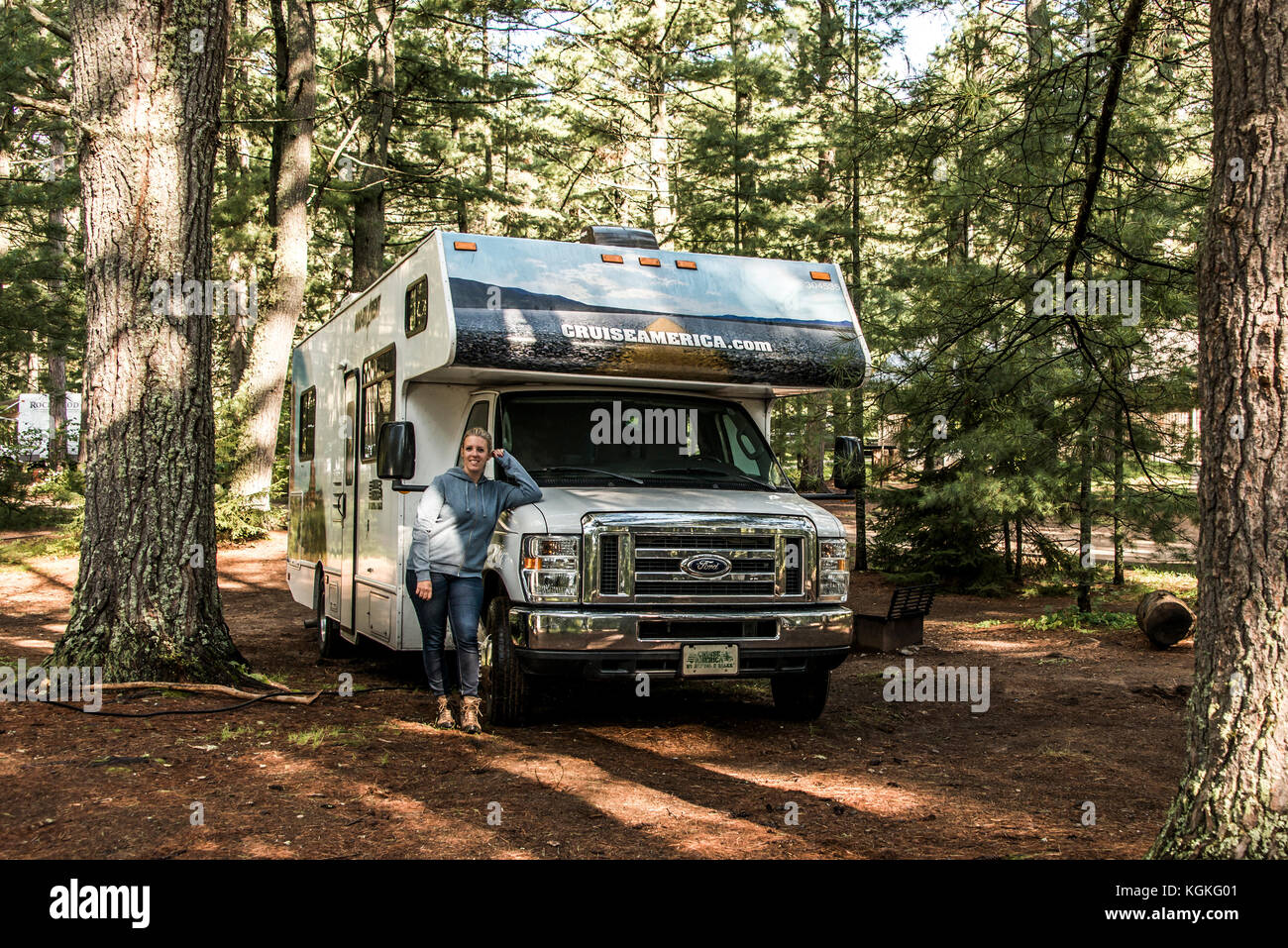 Canada Ontario Algonquin National Park 30.09.2017 - Woman in front of Parked RV camper car at Lake of two rivers Campground Beautiful natural forest C Stock Photo