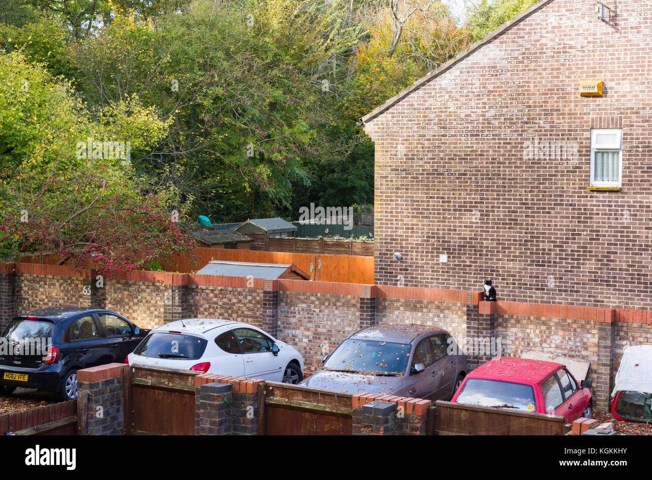 Cars parked in a private off road parking area in a residential suburban neighbourhood, Dorset, UK Stock Photo