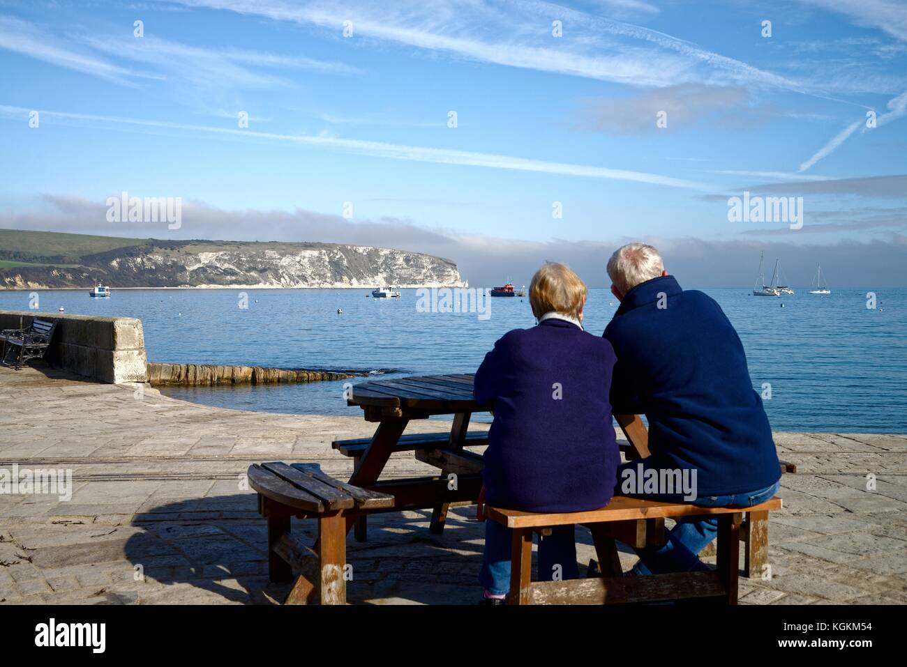 Old couple looking at the view of Swanage Bay Dorset England UK Stock Photo