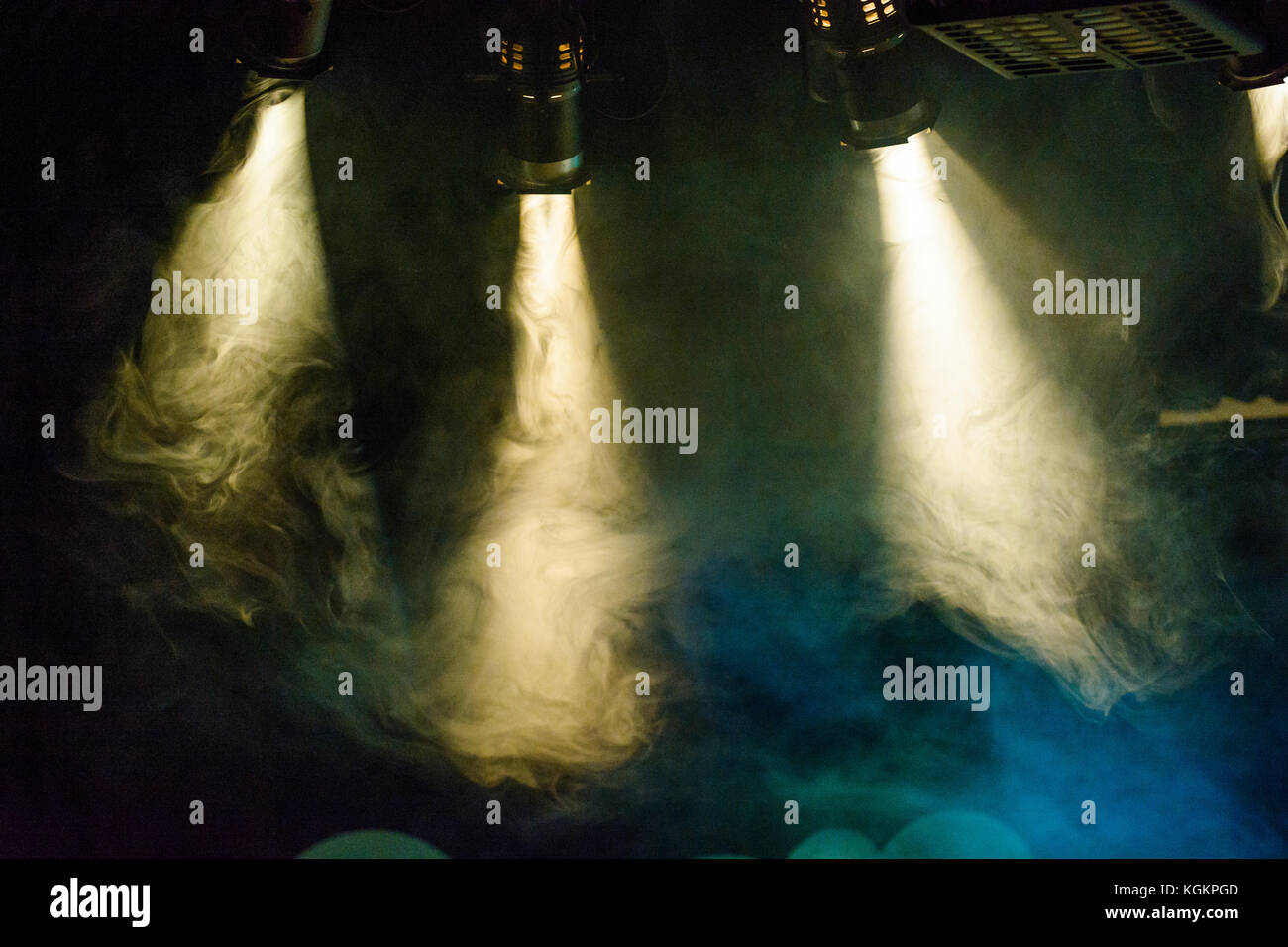 Stage lights shine through smoke Stock Photo Alamy